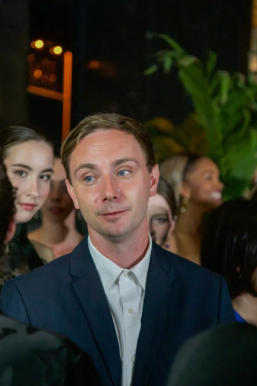 Cam Appleton in a navy blazer and white shirt at an evening event in Vancouver
