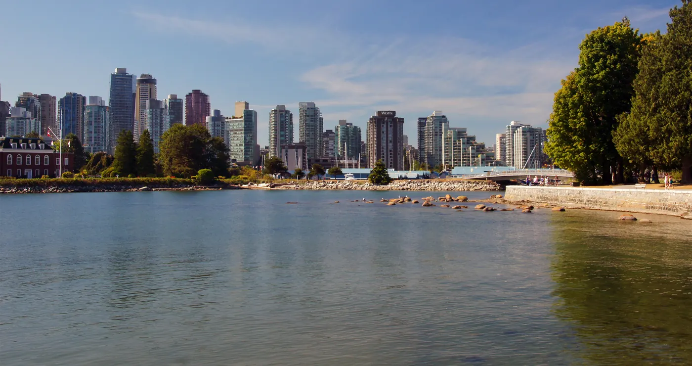 The West End skyline across calm water at English Bay
