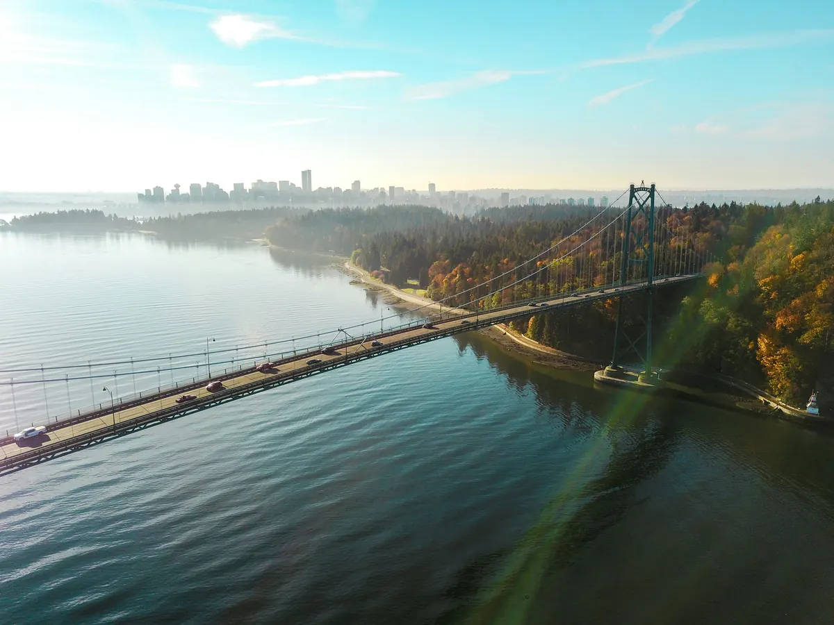 Aerial view of the Lions Gate Bridge over Burrard Inlet, with downtown Vancouver in the distance