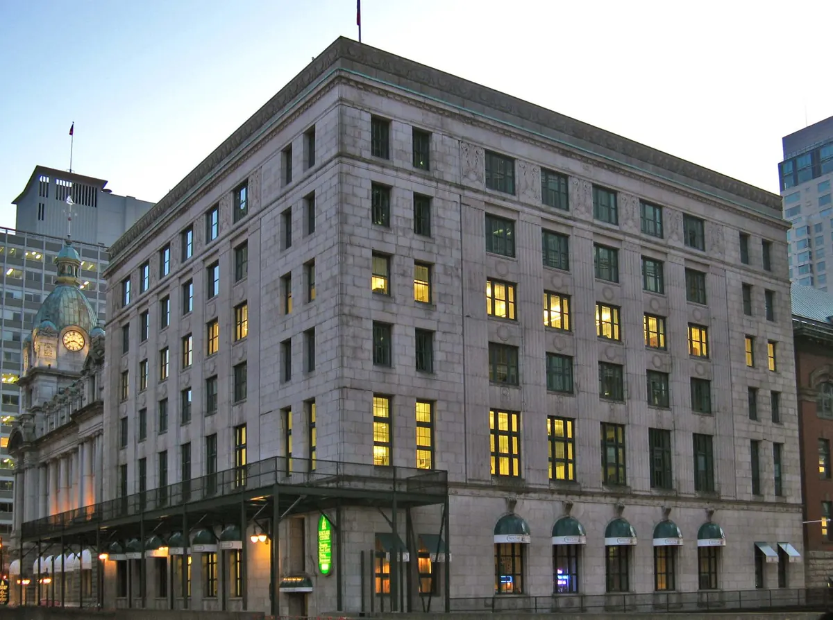 A mid-rise office building lit up at dusk